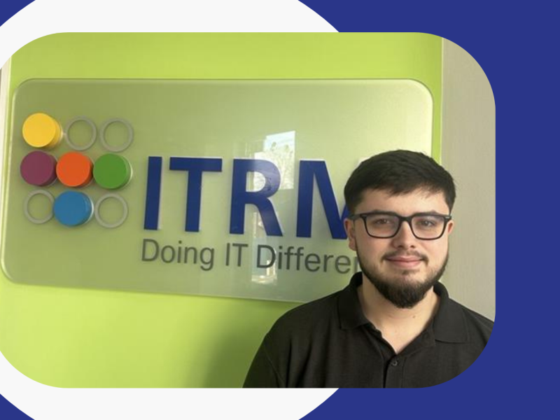 Alex Cox in front of ITRM Logo